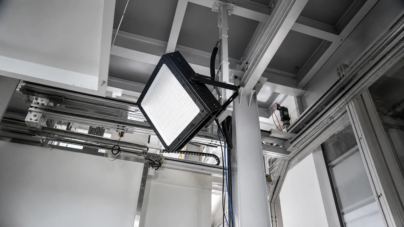Close view of an RT-IL 150°C 100 W fixture mounted inside industrial equipment.